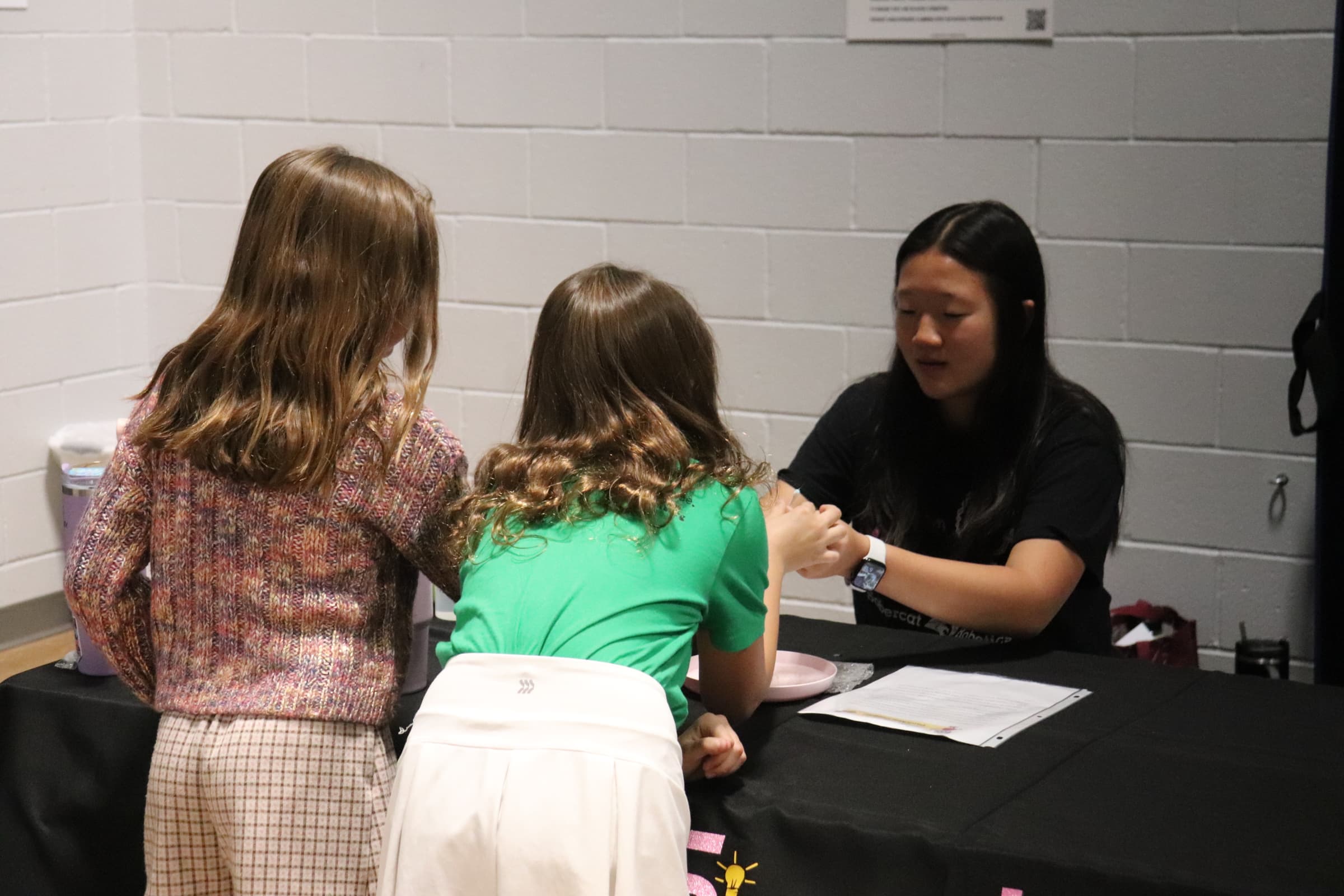 Young girl looking through microscope during an experiment at a SiS event